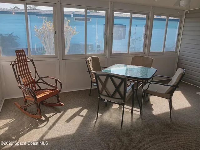 a view of a dining room with furniture and a window