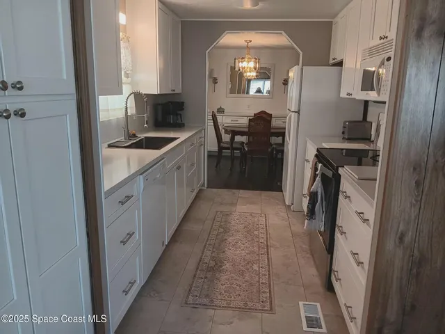a kitchen with cabinets and outdoor space