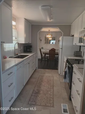 a kitchen with a sink and refrigerator
