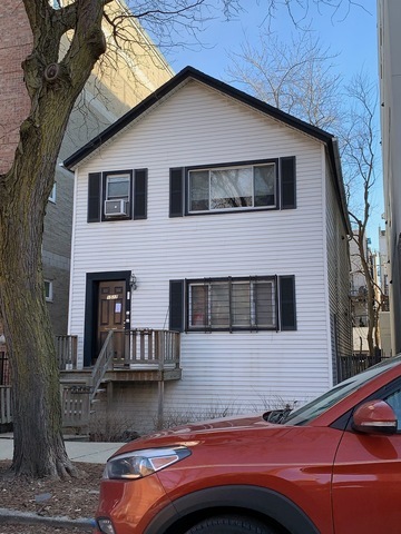 a front view of a house with parking space
