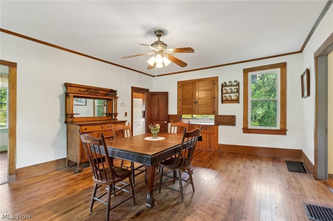 10571 Mayfield Road Chesterland, OH 44026 - Photo 7 of 39 Dining Room with hardwood built-in cupboard with passthrough to kitchen