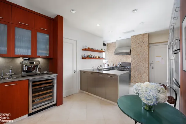 a kitchen with a refrigerator and a sink
