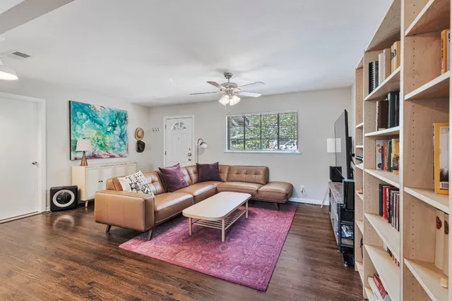 a living room with furniture and a book shelf