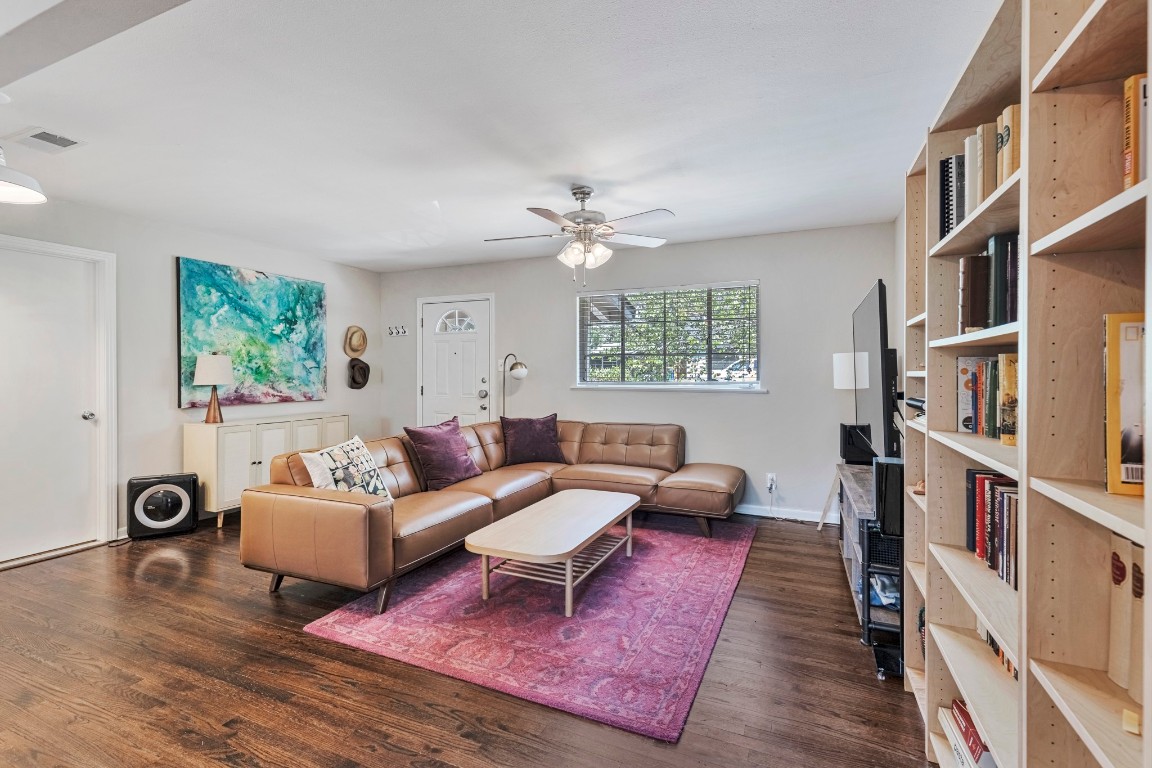 a living room with furniture and a book shelf