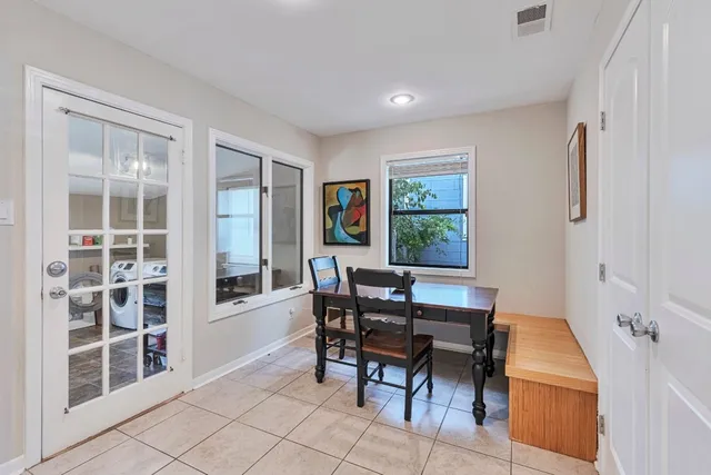a dining room with furniture and window