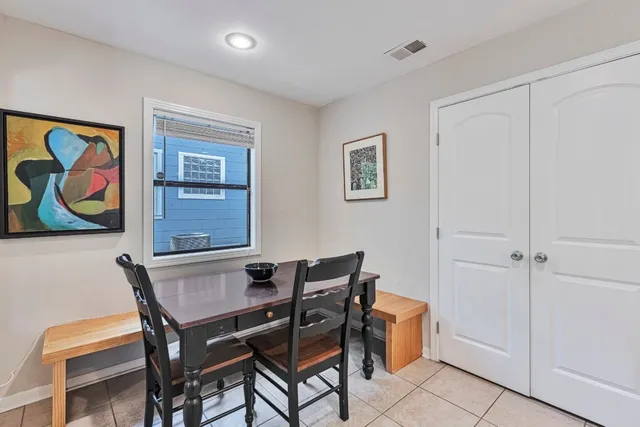 a dining room with furniture and wooden floor