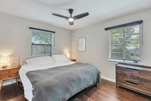 a bedroom with a large bed and a window