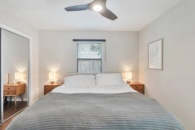 a bedroom with a large bed and a chandelier