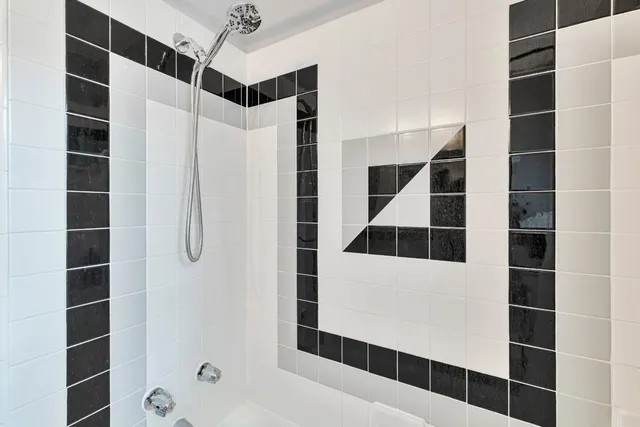 a bathroom with a shower and a mirror