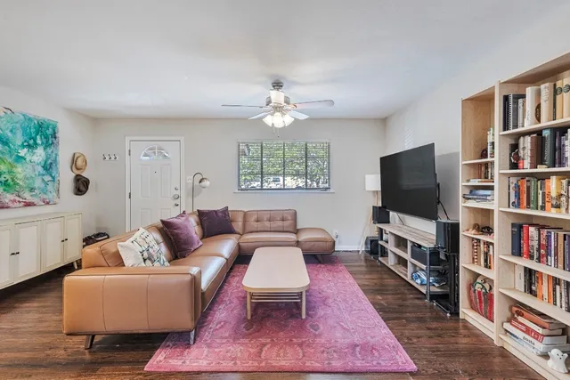 a living room with furniture a rug and a flat screen tv