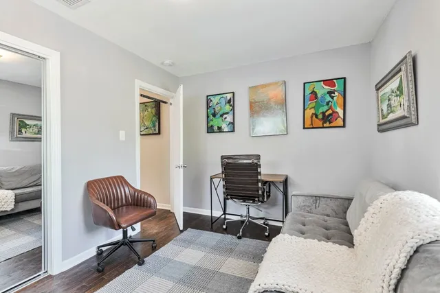 a living room with furniture and a piano