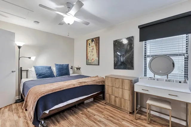 a bedroom with a bed dresser and a window