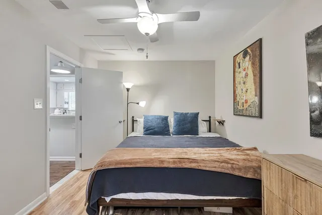 a bedroom with a bed and a chandelier