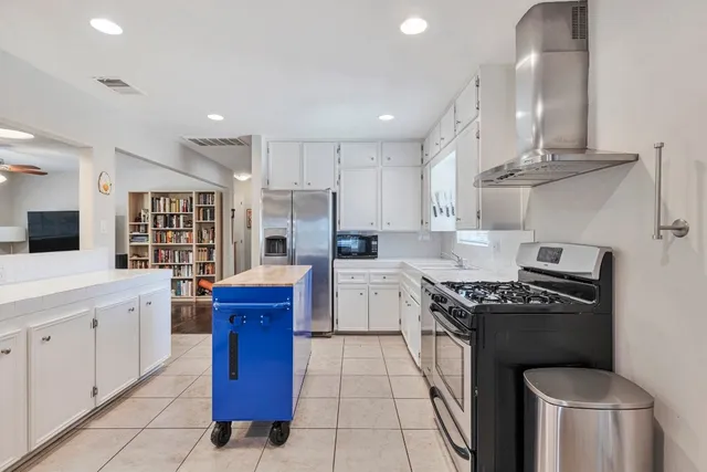 a kitchen with stainless steel appliances granite countertop a stove a sink dishwasher and a refrigerator
