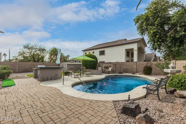 a view of a backyard with sitting area