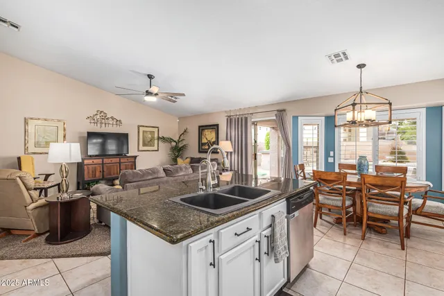a kitchen with granite countertop a sink counter top space and stainless steel appliances