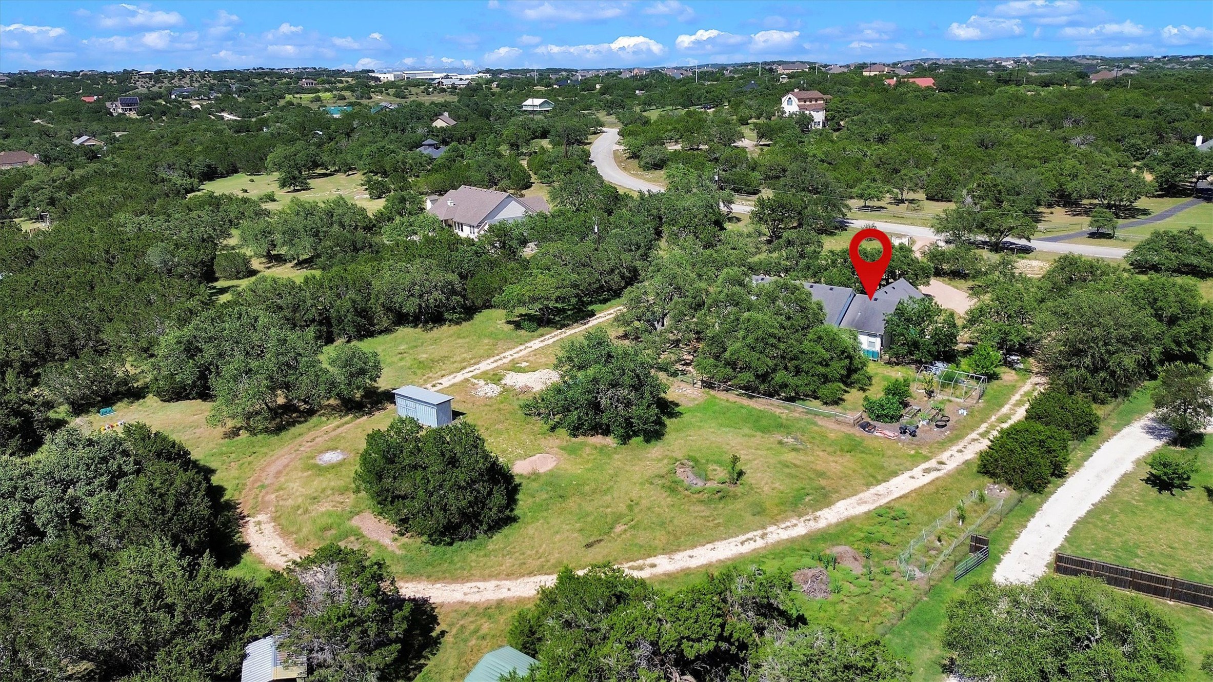 1120 Meadow Ridge Drive Austin, TX 78737 - Photo 37 of 40 A verdant, sprawling property with a house nestled among abundant trees and open space.