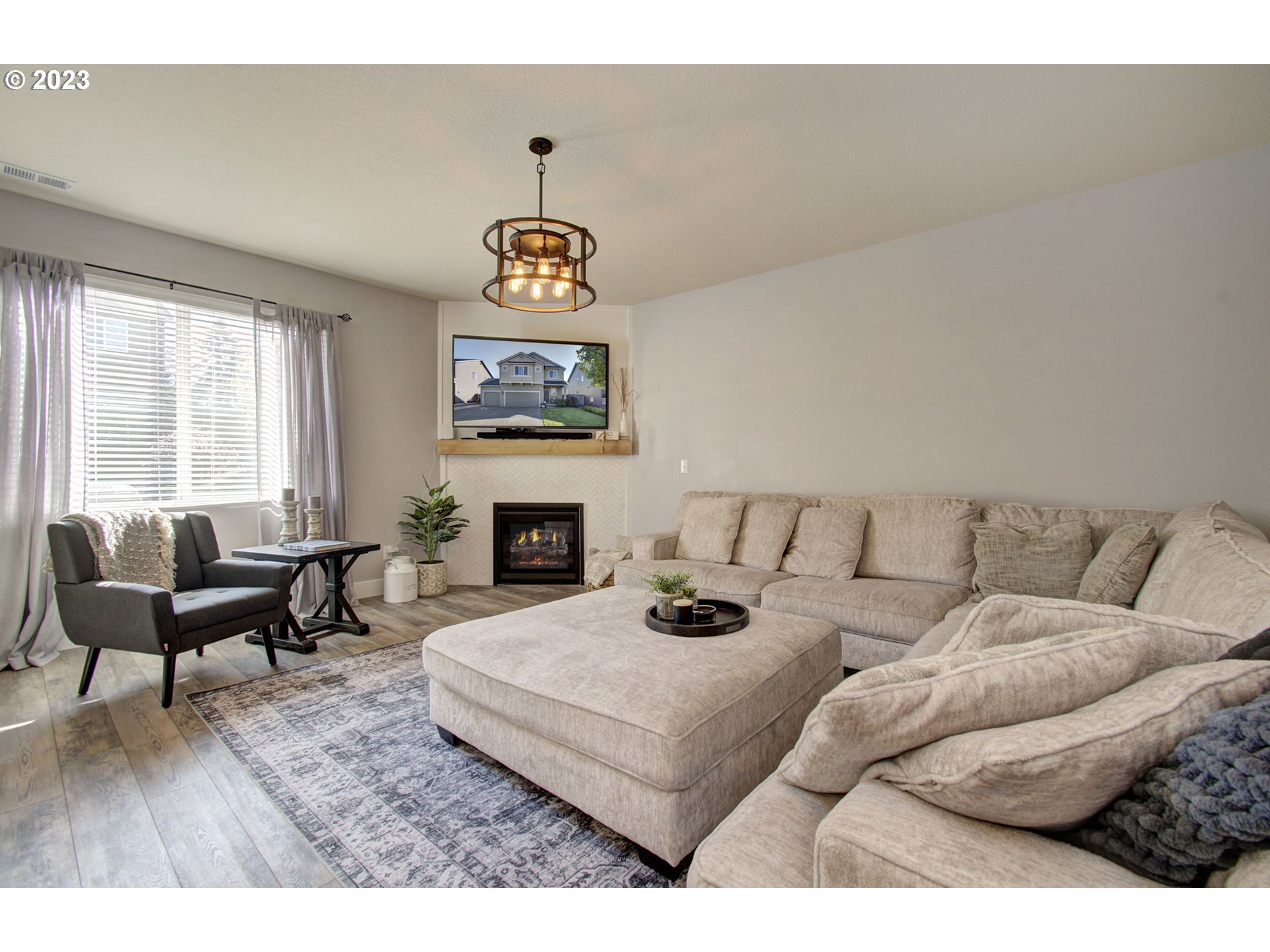 871 North 35th Avenue Ridgefield, WA 98642 - Photo 5 of 36 a living room with furniture a fireplace and a large mirror