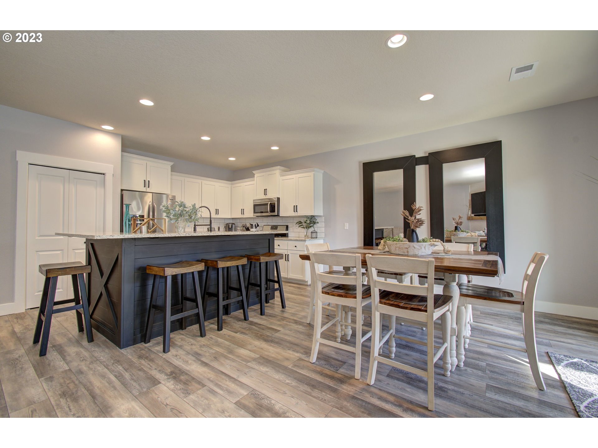 871 North 35th Avenue Ridgefield, WA 98642 - Photo 6 of 36 a dining hall with stainless steel appliances a dining table and chairs