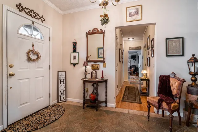 a view of a dining room with furniture and chandelier