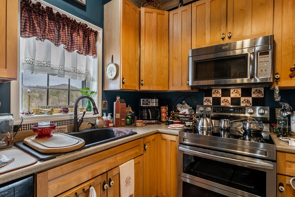 112 Deer Ridge Drive Murphy, NC 28906 - Photo 37 of 55 a kitchen with stainless steel appliances a stove a sink and a microwave