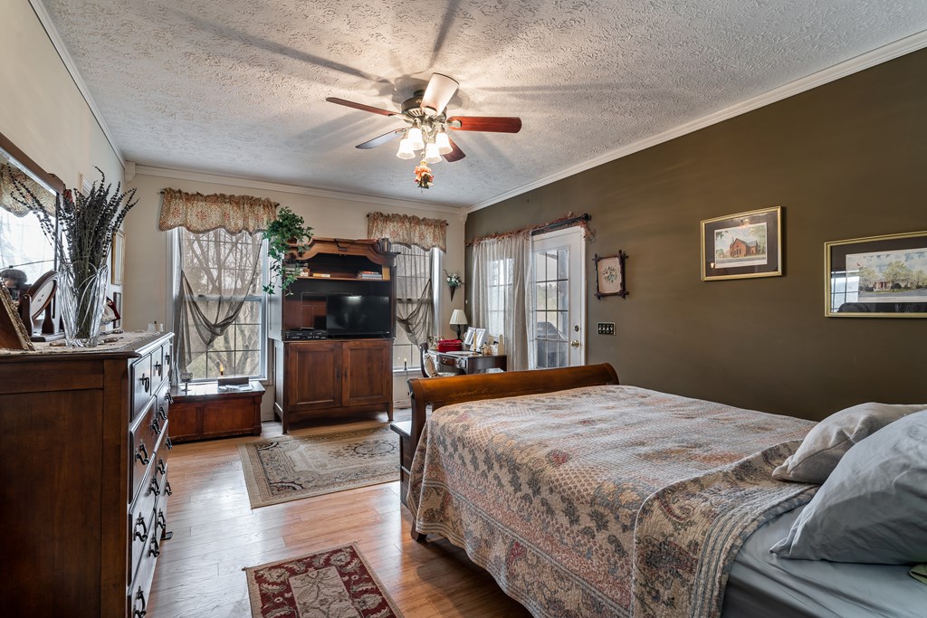 112 Deer Ridge Drive Murphy, NC 28906 - Photo 45 of 55 a bedroom with a bed and a chandelier