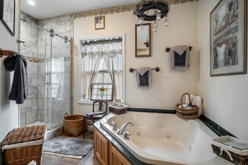 112 Deer Ridge Drive Murphy, NC 28906 - Photo 48 of 55 a bathroom with a granite countertop sink a mirror and shower