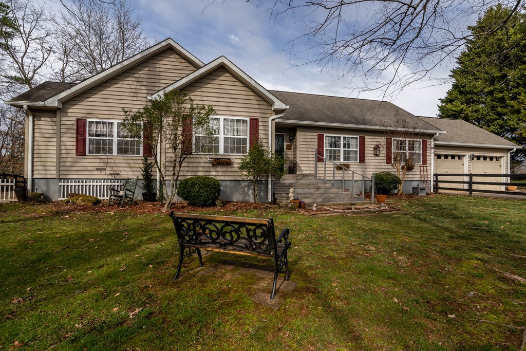 112 Deer Ridge Drive Murphy, NC 28906 - Photo 5 of 55 a view of a house with a chairs in a patio