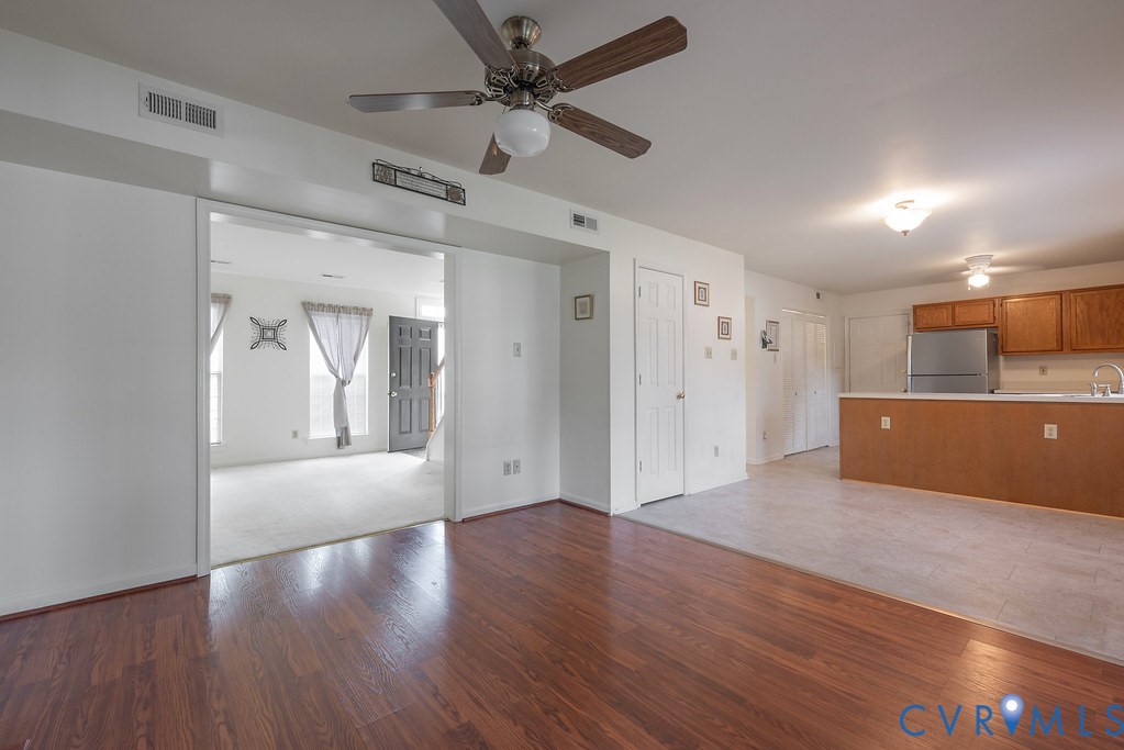6332 Springcrest Lane Richmond, VA 23231 - Photo 18 of 38 a view of kitchen and empty room with wooden floor
