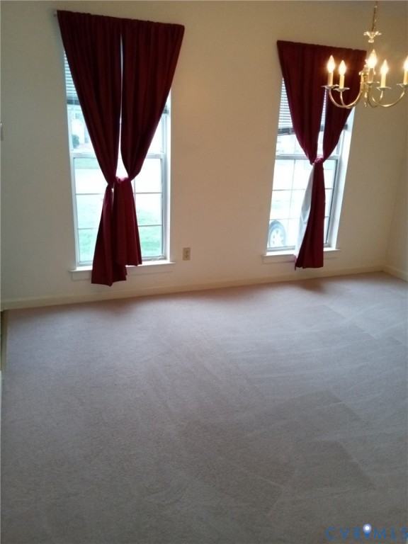 6332 Springcrest Lane Richmond, VA 23231 - Photo 23 of 38 an empty room with windows and stairs