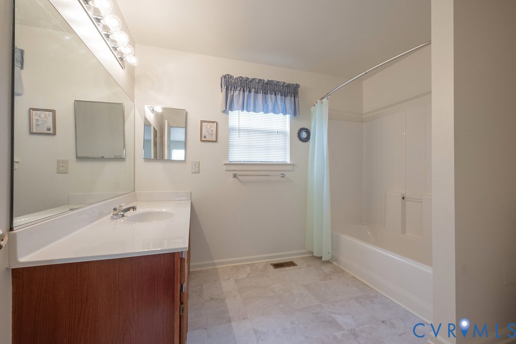 6332 Springcrest Lane Richmond, VA 23231 - Photo 24 of 38 a bathroom with a sink a shower and a mirror