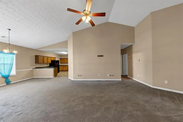 a view of empty room with ceiling fan