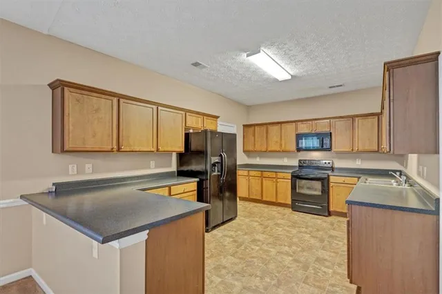 a kitchen with a refrigerator sink and stove