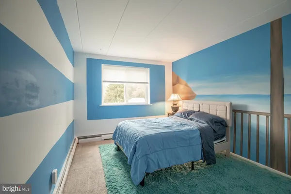 a bedroom with a large bed and a dresser