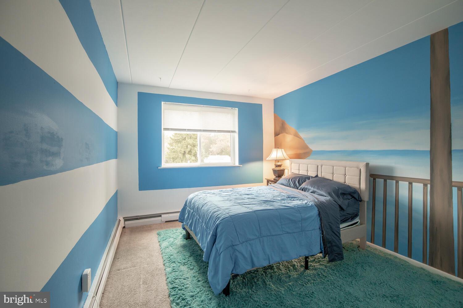 1575 West Street Road, Unit 626 Warminster, PA 18974 - Photo 13 of 22 a bed sitting in a bedroom next to a window