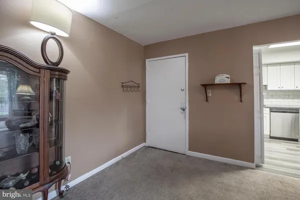 a view of a livingroom with wooden floor and cabinets