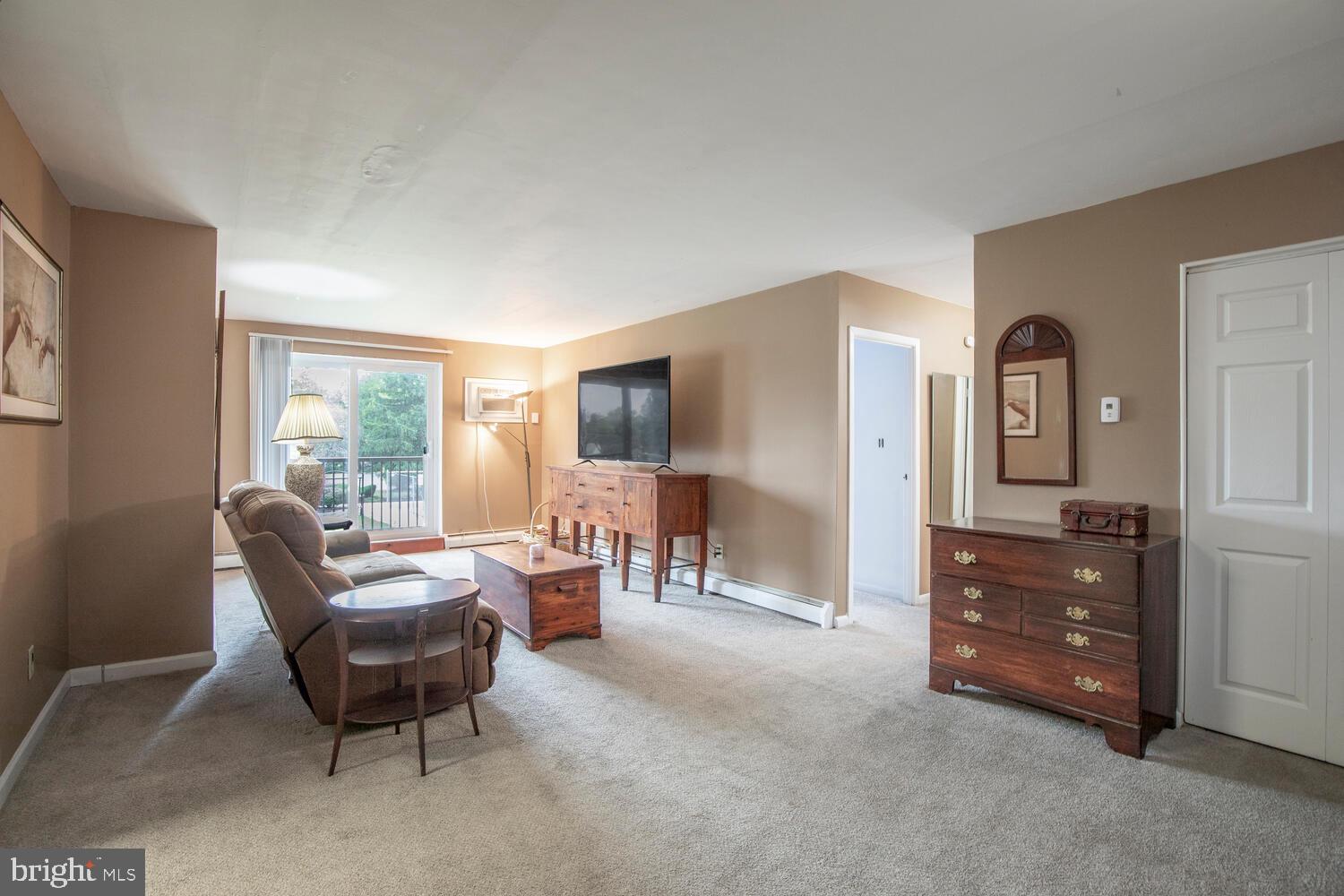 1575 West Street Road, Unit 626 Warminster, PA 18974 - Photo 9 of 22 a living room with furniture and a flat screen tv