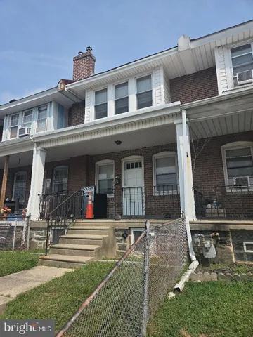 front view of a brick house with a yard