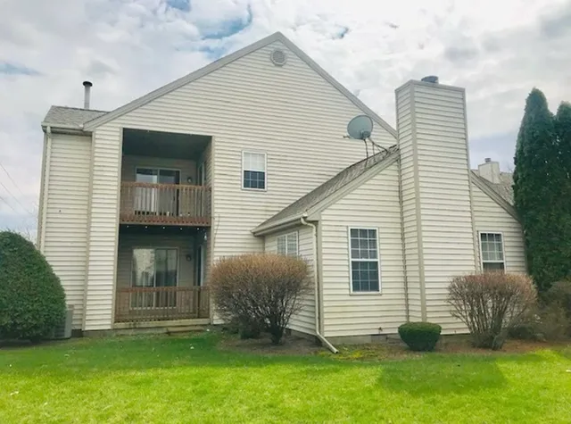 a front view of house with a garden