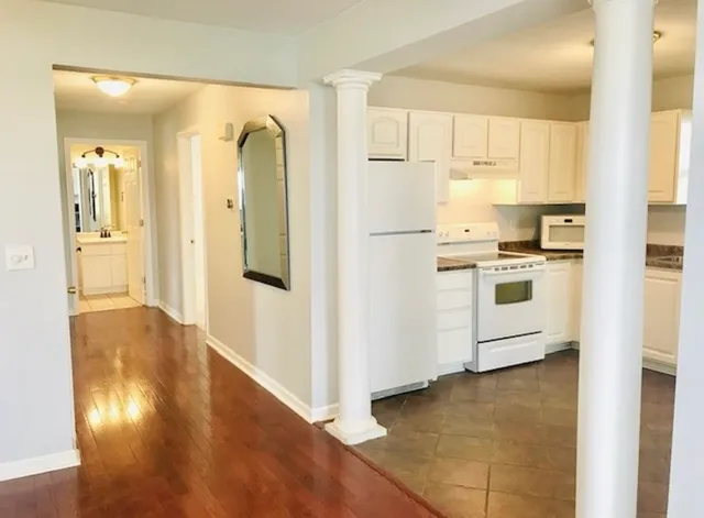 a view of a hallway with wooden floor