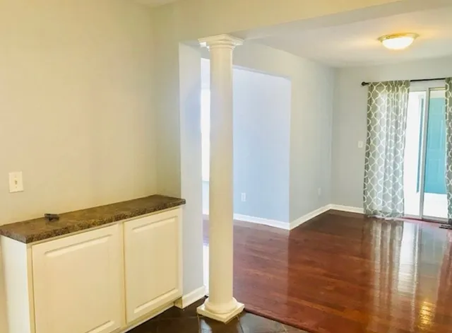 a view of walk in closet with wooden floor