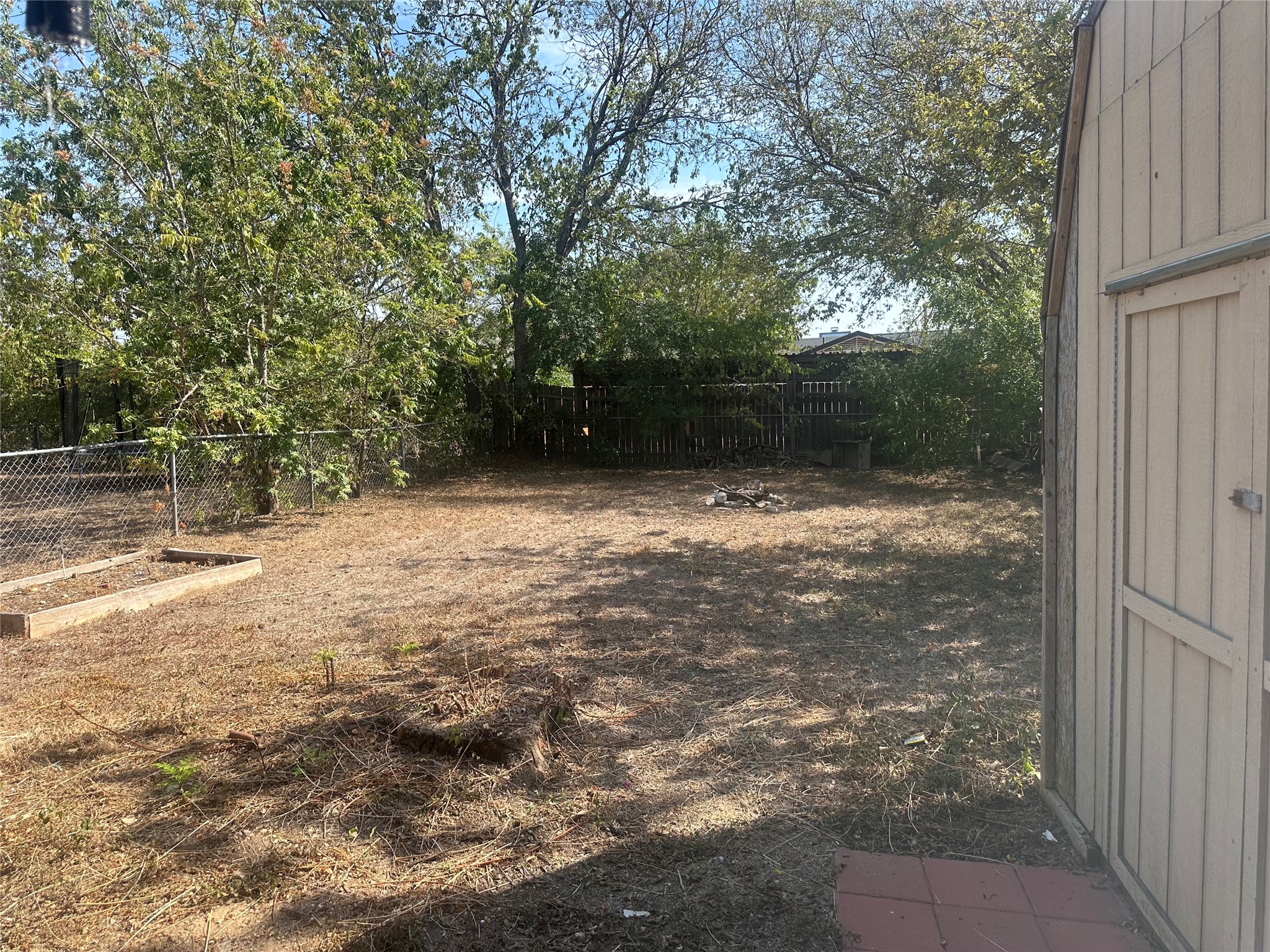 2602 South Bagdad Road, Unit B Leander, TX 78641 - Photo 21 of 23 Mature trees frame a spacious backyard offering ample room for outdoor activities.