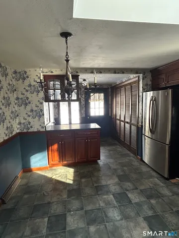 a kitchen with stainless steel appliances granite countertop a sink and wooden cabinets