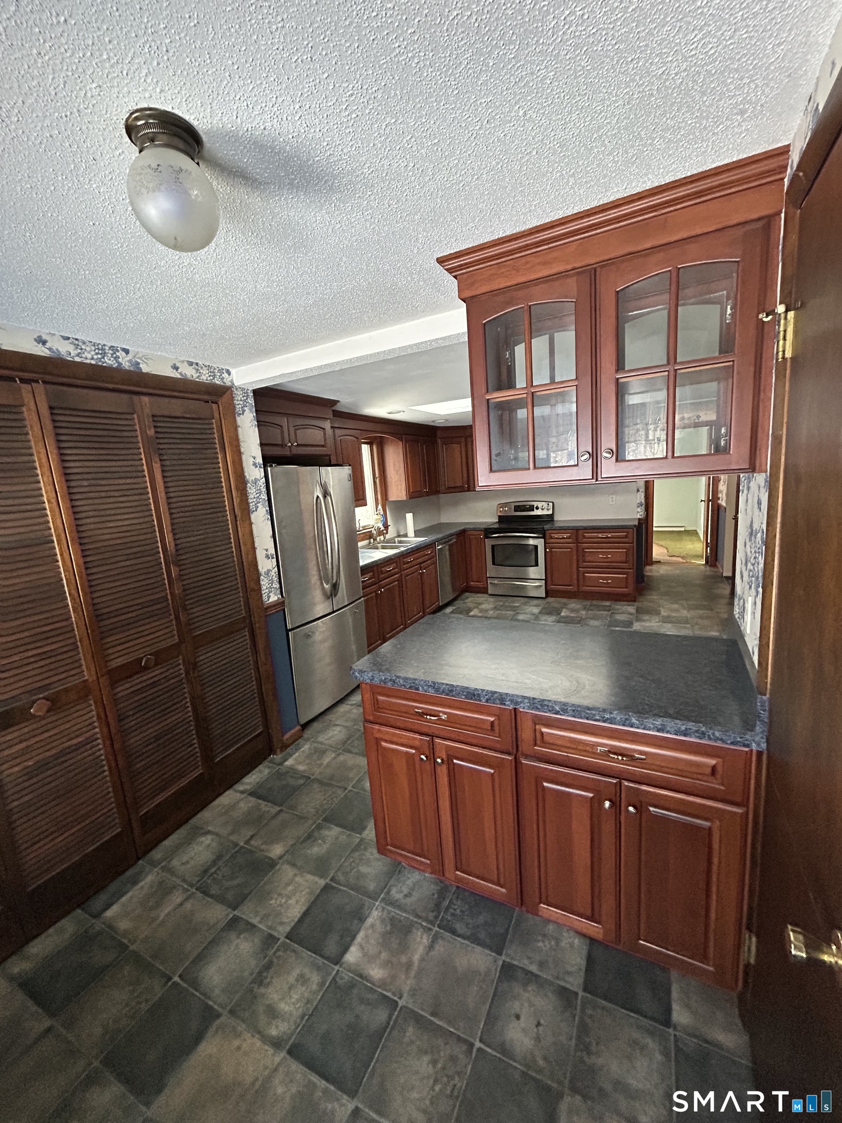 65 Munson Road Wolcott, CT 06716 - Photo 12 of 28 a kitchen with stainless steel appliances granite countertop a sink and wooden cabinets