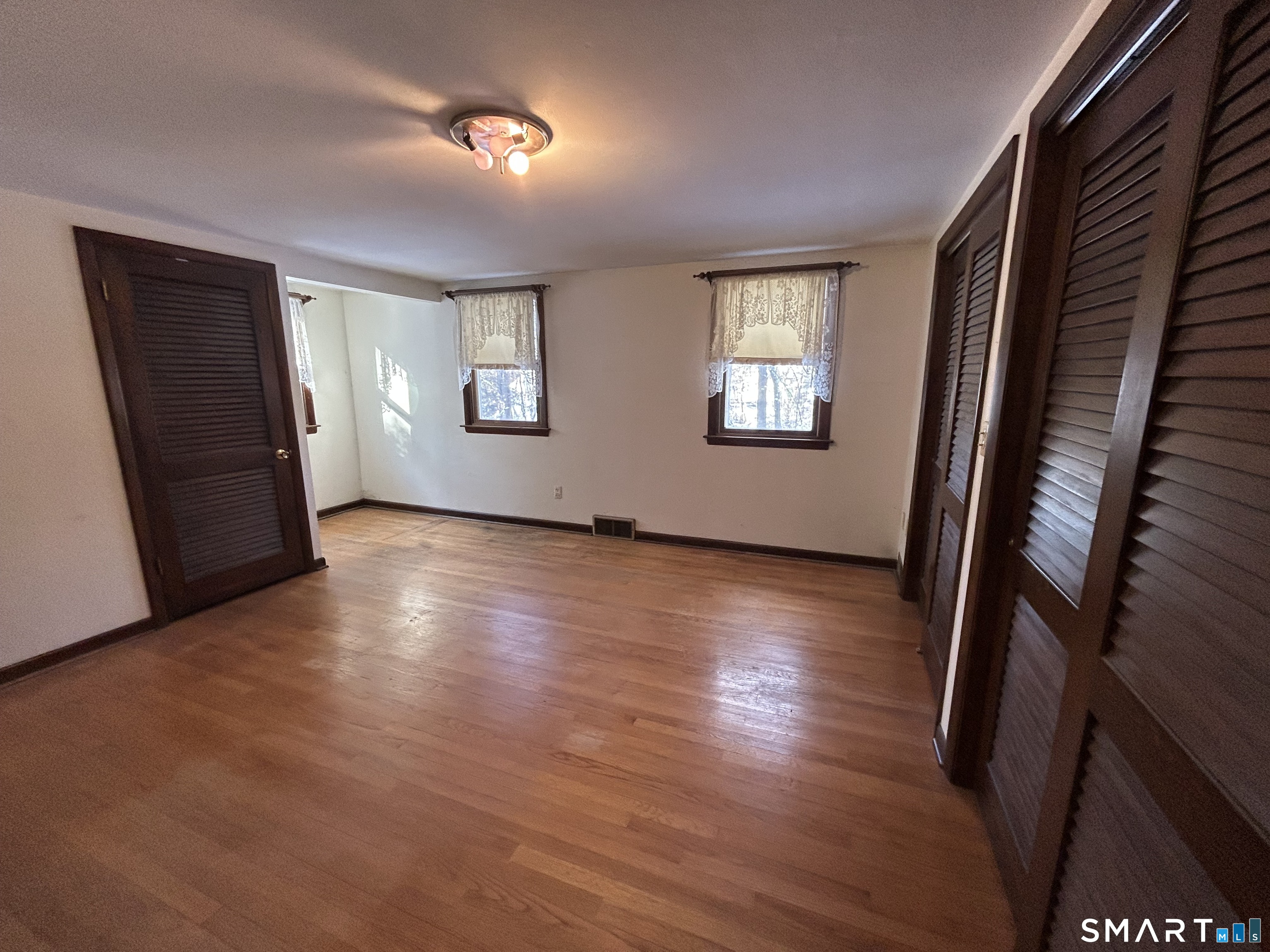 65 Munson Road Wolcott, CT 06716 - Photo 18 of 28 an empty room with wooden floor and windows