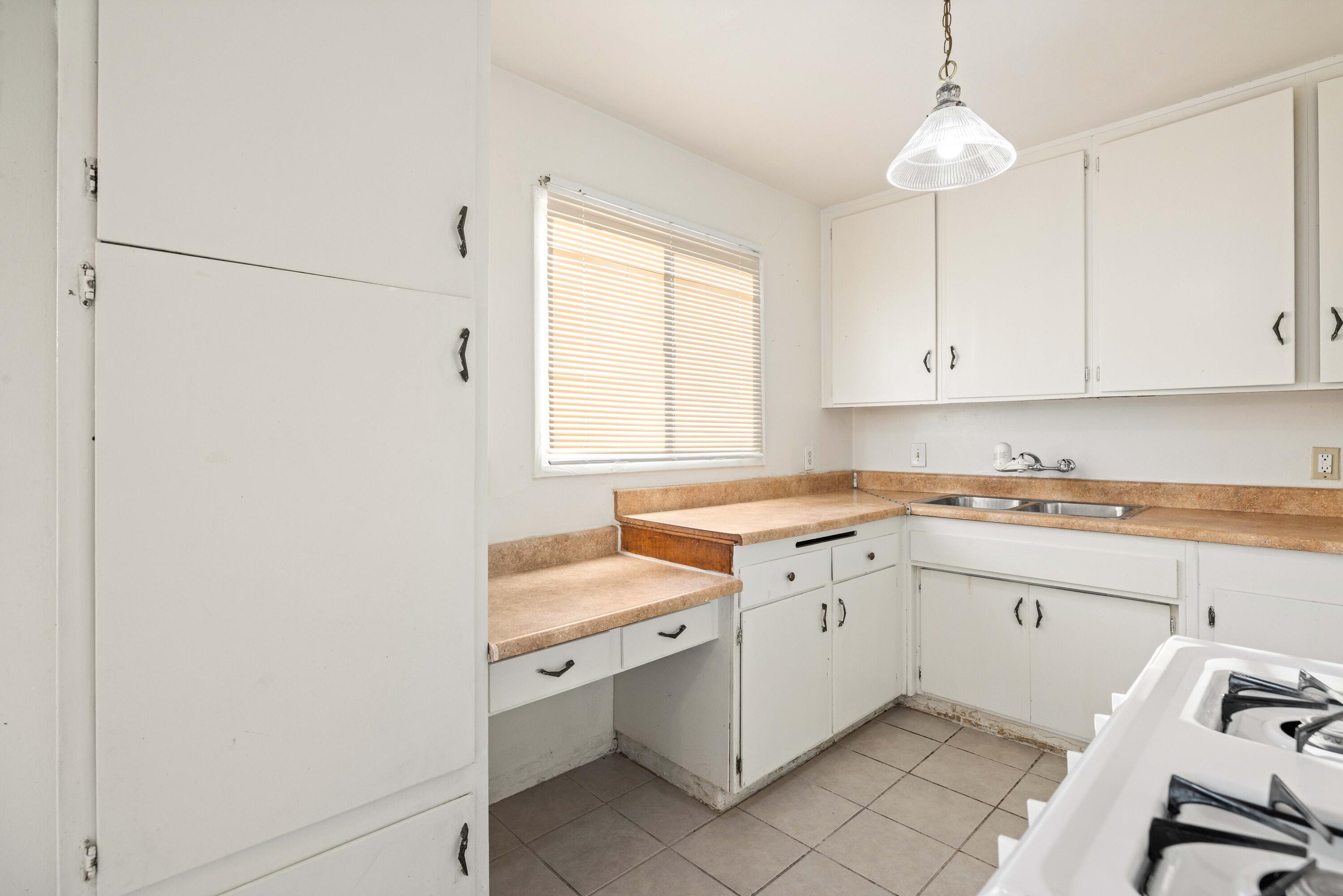 45433 Lorimer Avenue Lancaster, CA 93534 - Photo 11 of 23 a kitchen with a sink cabinets and window