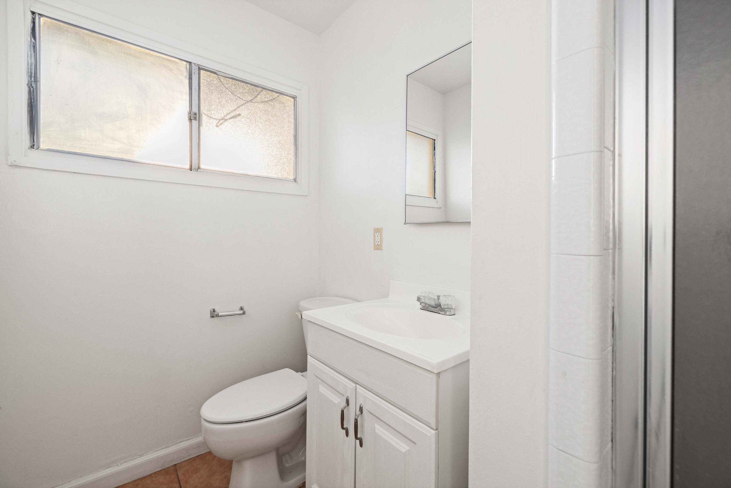 45433 Lorimer Avenue Lancaster, CA 93534 - Photo 18 of 23 a bathroom with a sink toilet and mirror