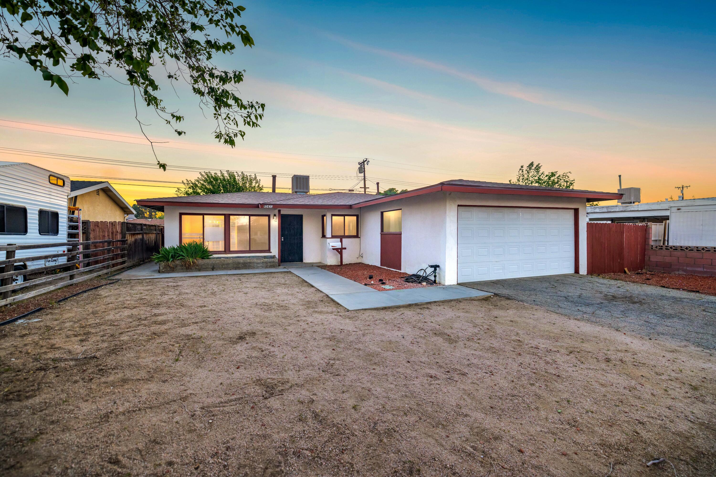 45433 Lorimer Avenue Lancaster, CA 93534 - Photo 2 of 23 a view of a house with a yard and sitting area