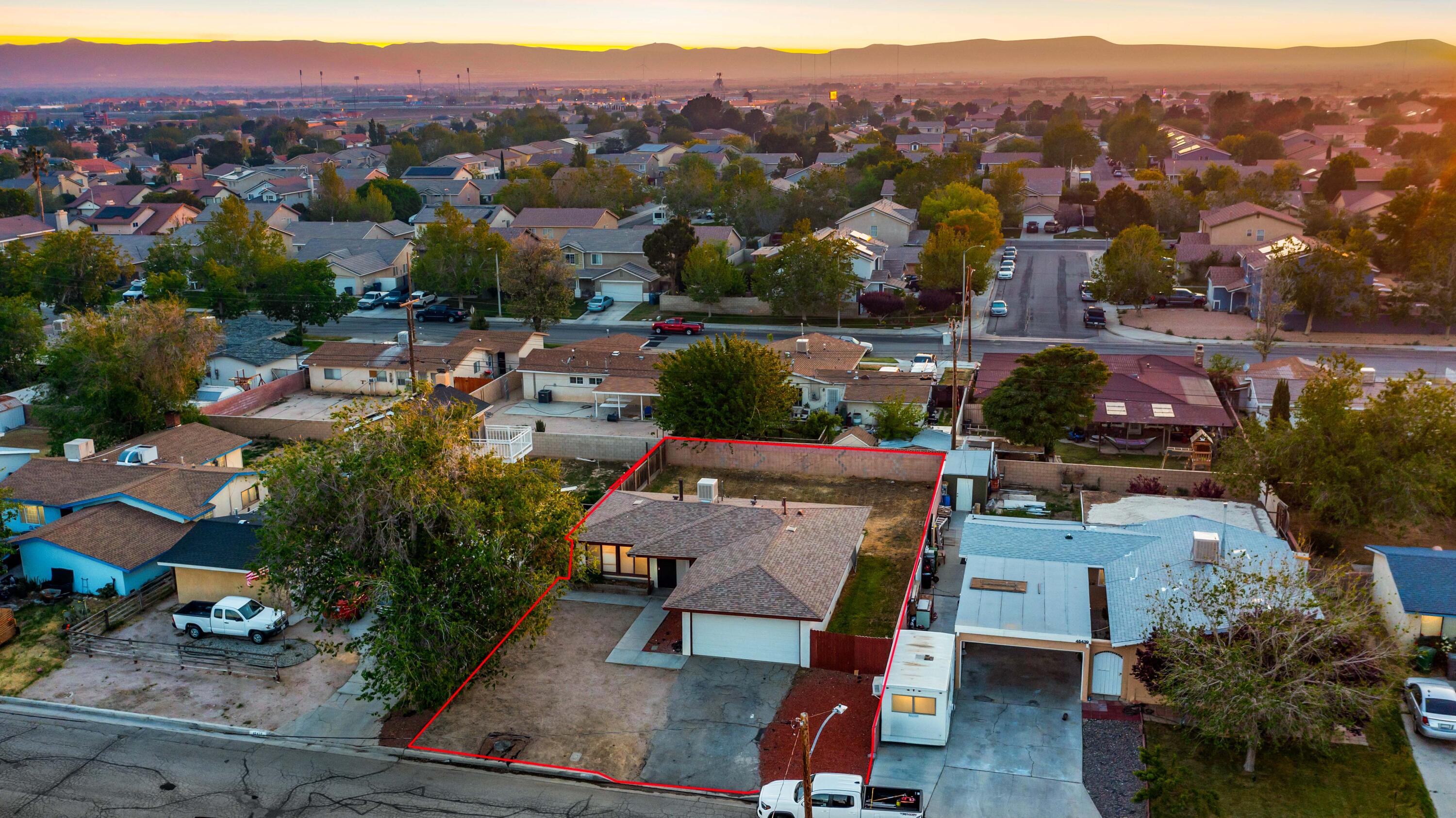 45433 Lorimer Avenue Lancaster, CA 93534 - Photo 3 of 23 an aerial view of a city with lots of residential buildings and mountain view in back