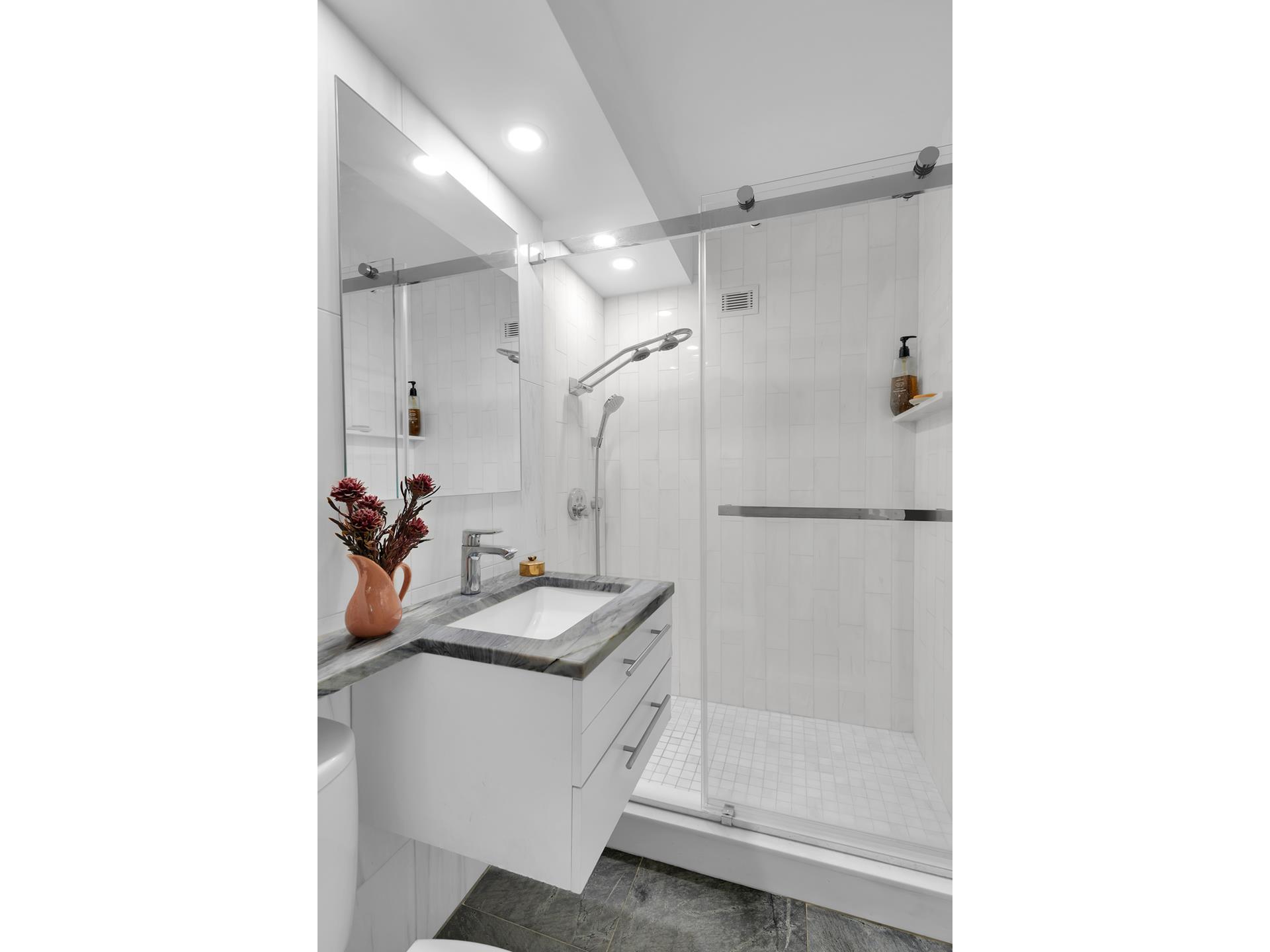 446 East 86th Street, Unit 2EF Manhattan, NY 10028 - Photo 9 of 10 a bathroom with a sink and mirror